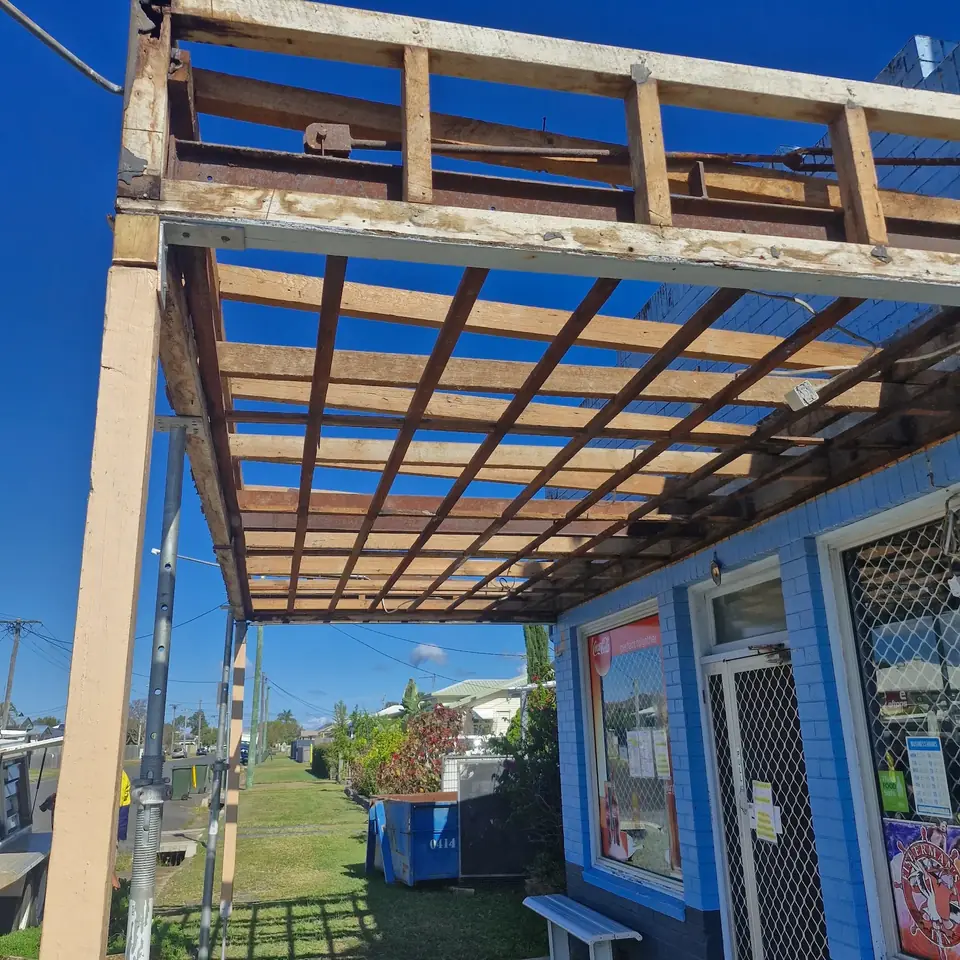 Verandah roof stripped back to timber framing during demolition work