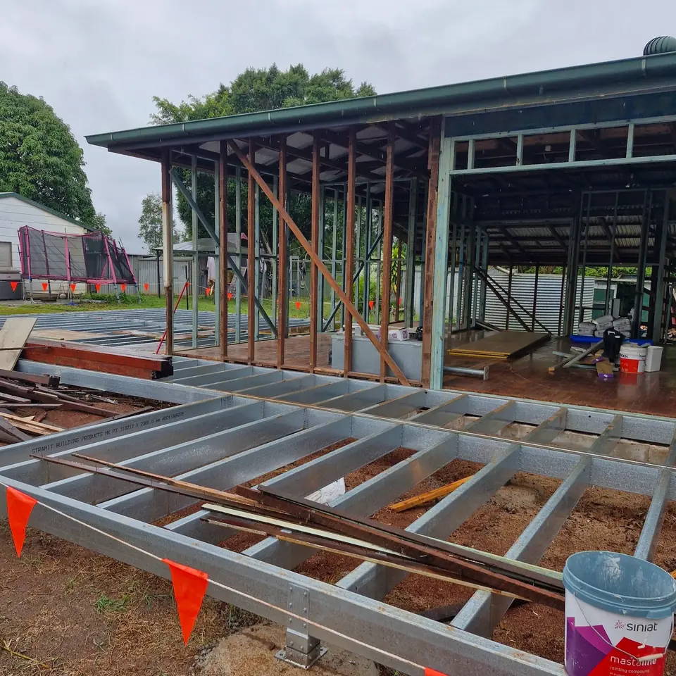 House strip-out with exposed floor joists, wall framing and open structure