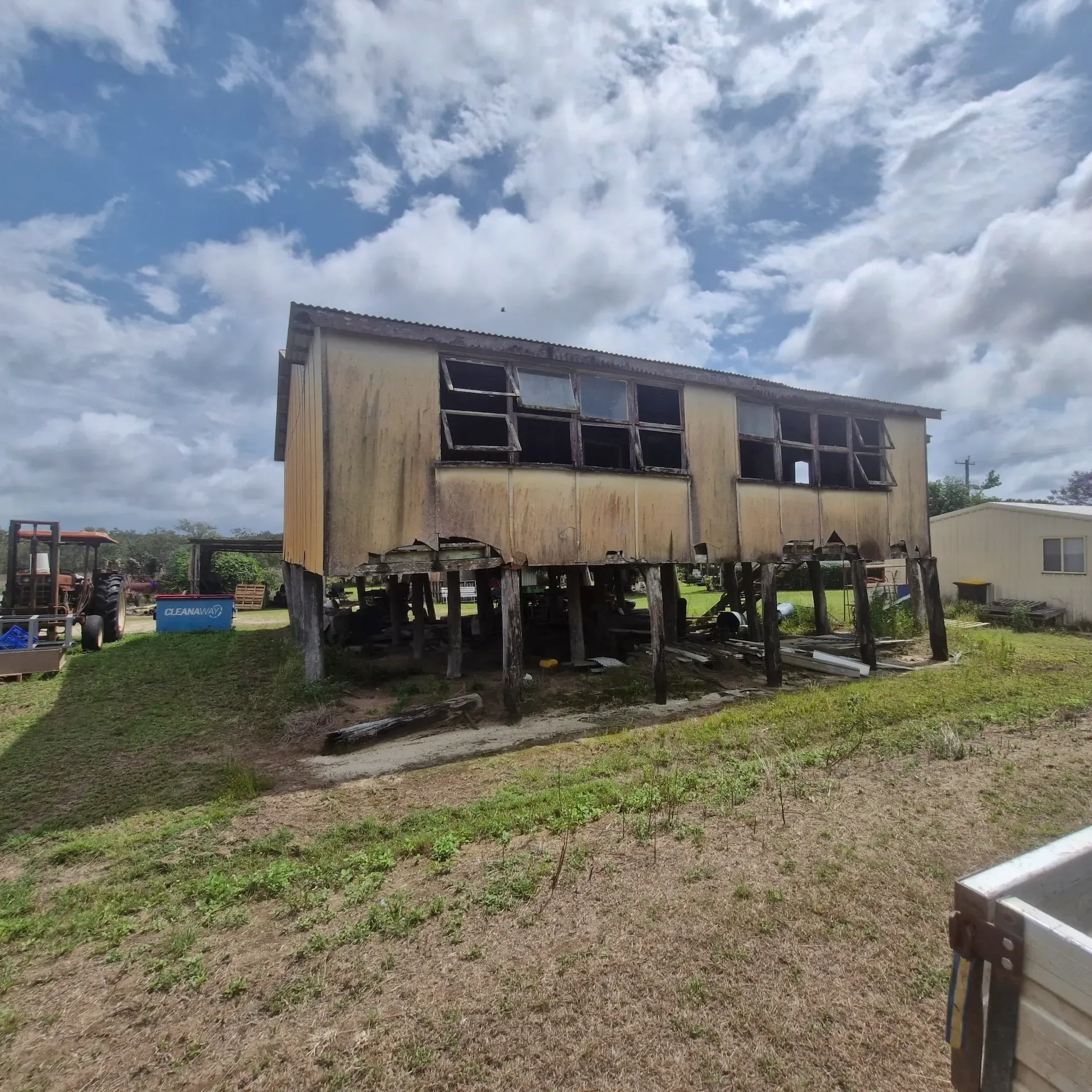 Raised timber residential building on an open grassed site