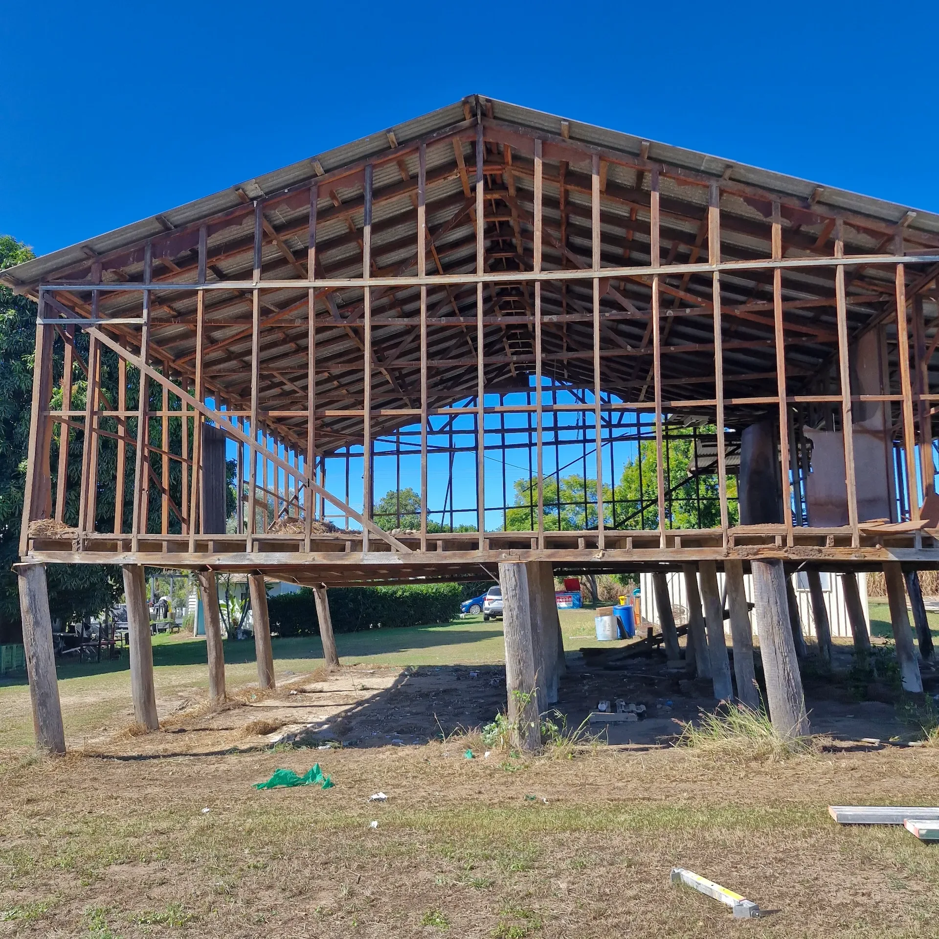 Raised timber house stripped back to its structural frame during demolition work